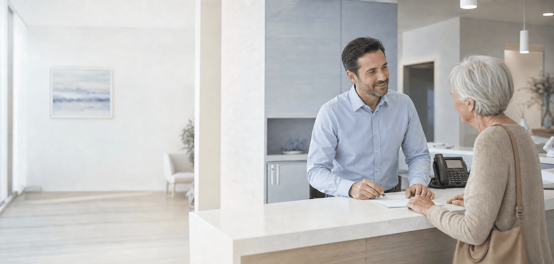 A professionally dressed healthcare receptionist helping an older patient
